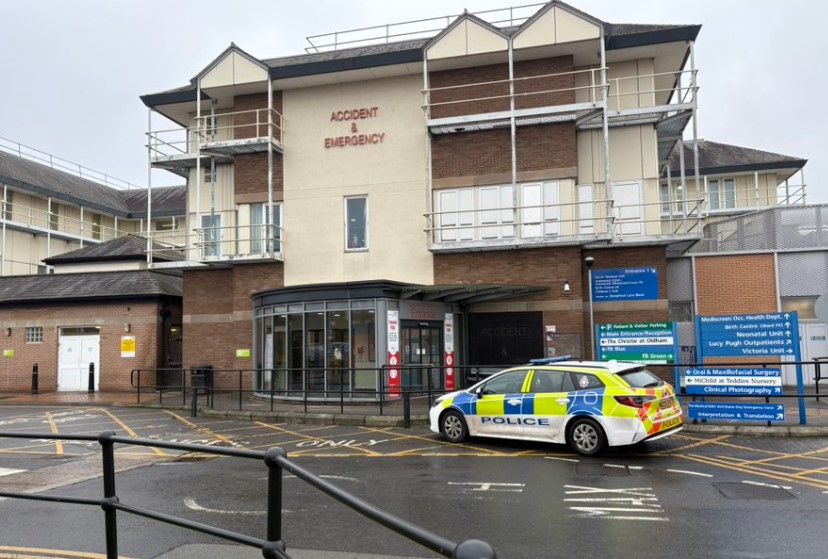 Police car parked outside a hospital's accident and emergency department.