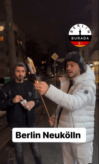 Atallah Younes lighting a firework in Berlin Neukölln.