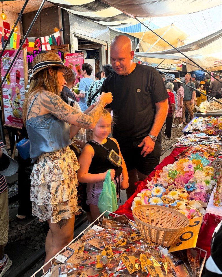 Family at a market browsing souvenirs.