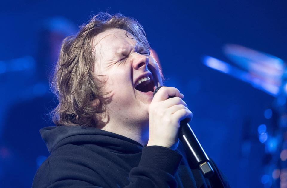 Lewis Capaldi performing live on stage.