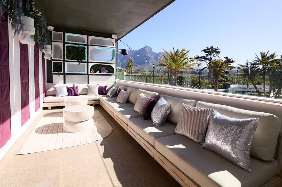 Love Island All Stars villa balcony with seating area and mountain view.