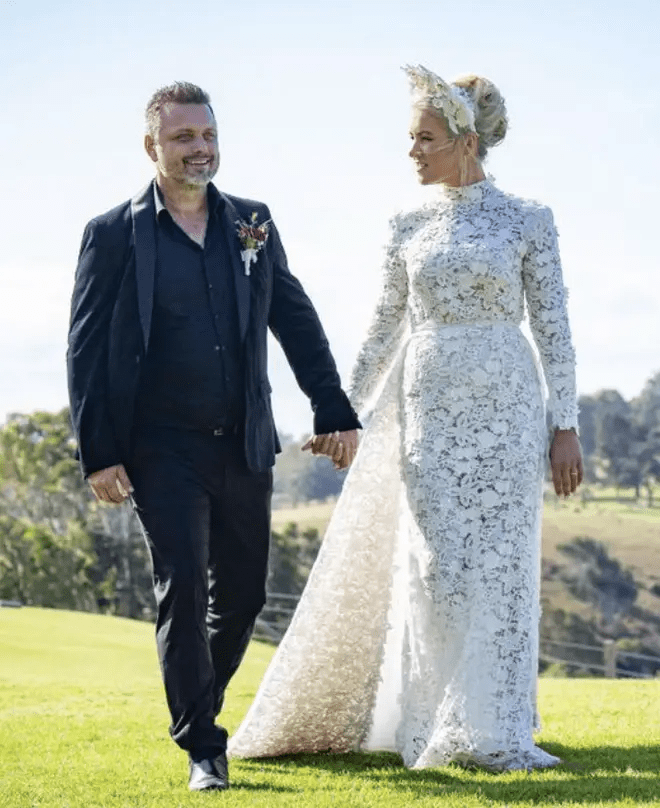 Couple holding hands on their wedding day.