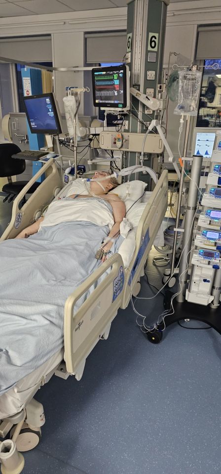 Woman in induced coma in hospital bed.