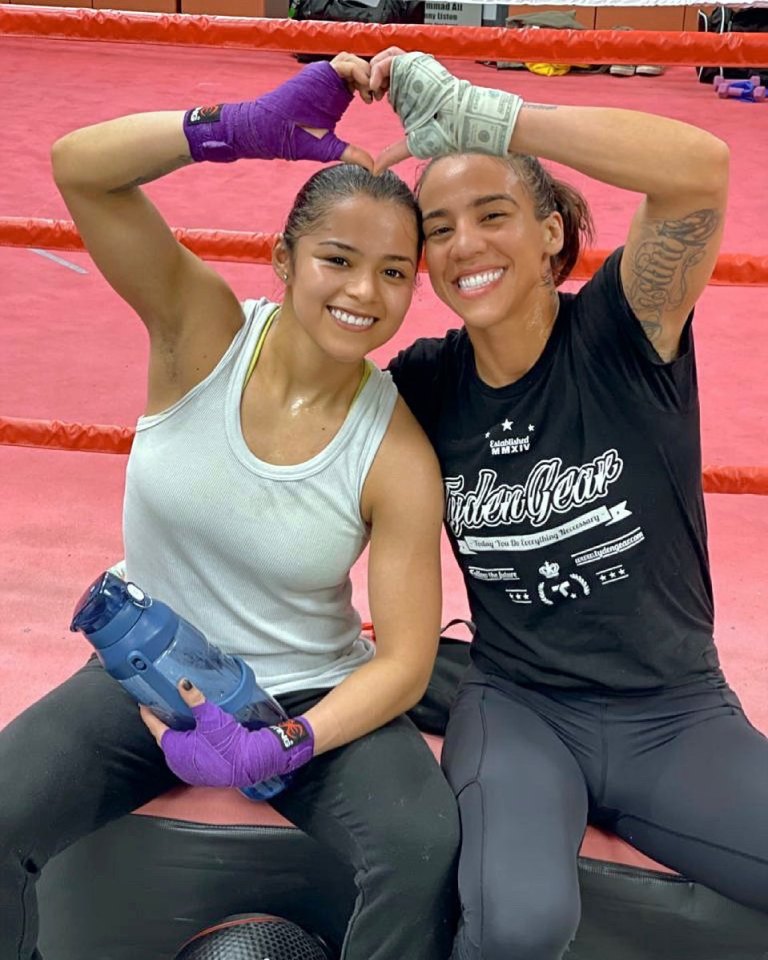 Jessica Camara and Erika Jeanette Hernandez making a heart shape with their hands.