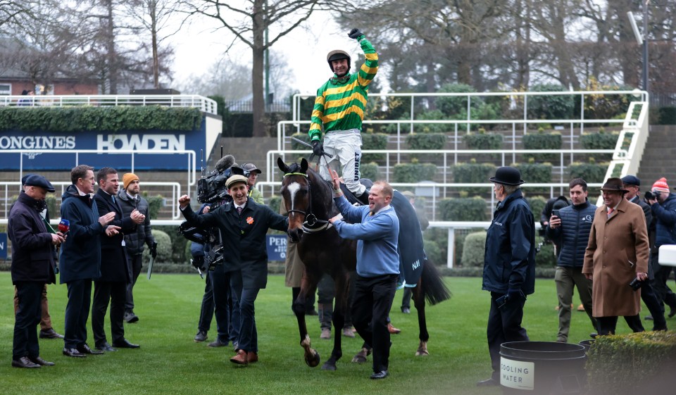 Jockey Nico de Boinville celebrates winning a horse race.