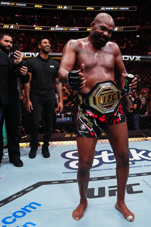 Jon Jones giving a thumbs-up after winning a UFC heavyweight championship fight.