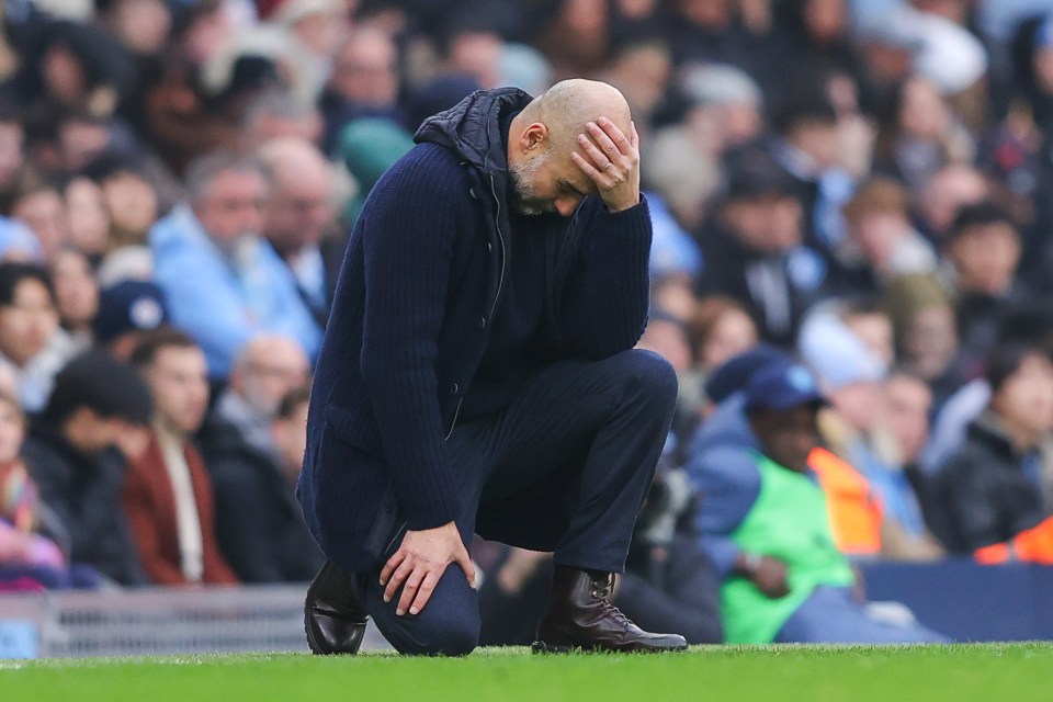 Pep Guardiola kneeling dejectedly on the field.