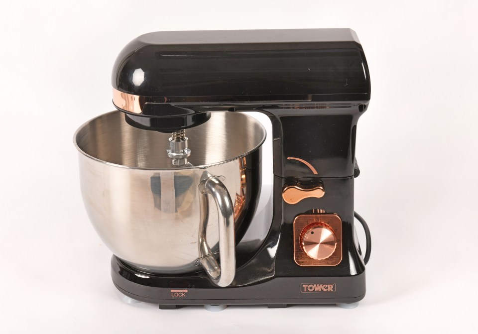 Black and copper stand mixer with stainless steel bowl.