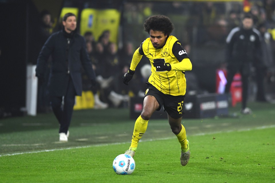 Karim Adeyemi of Borussia Dortmund controls the ball during a soccer match.