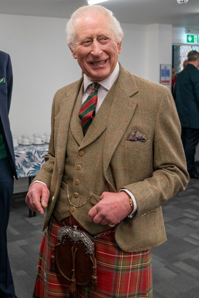 King Charles III visiting a charity that supports the homeless.