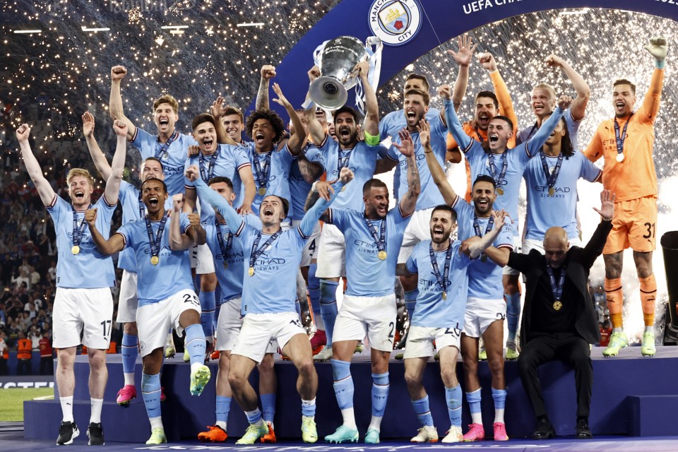 Manchester City FC team celebrating their UEFA Champions League victory.