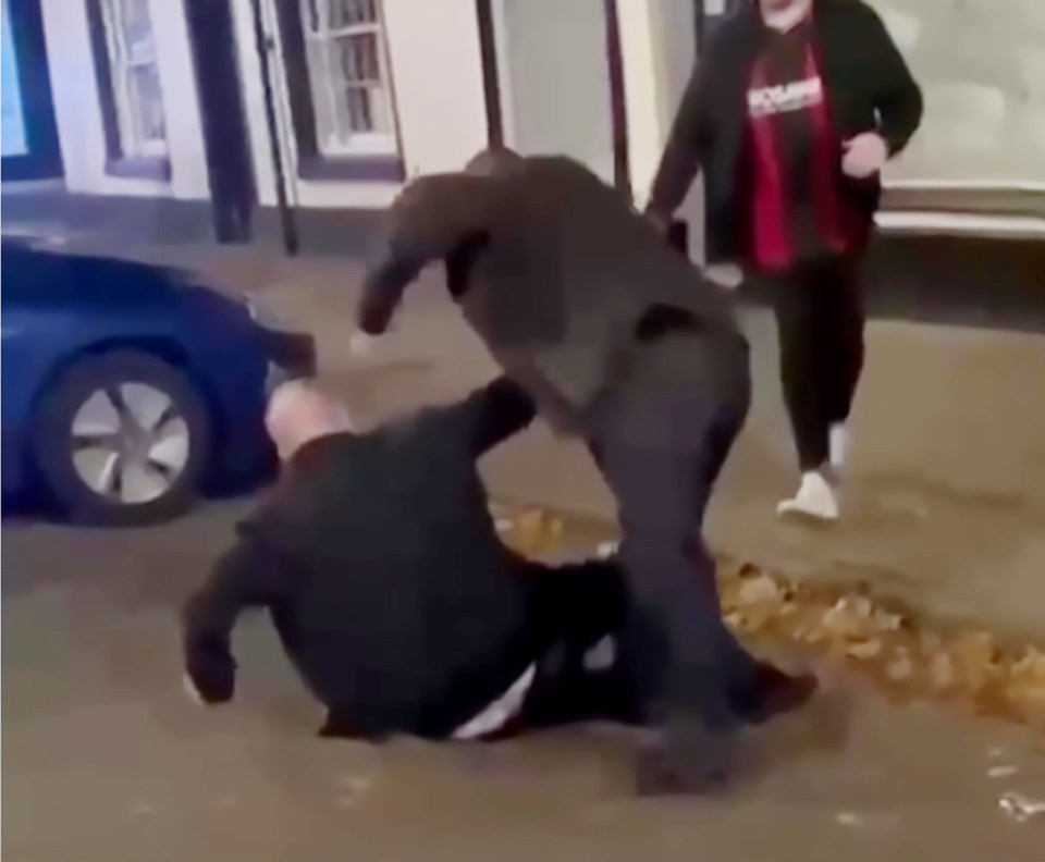 MP Mike Amesbury punching a person on the ground.