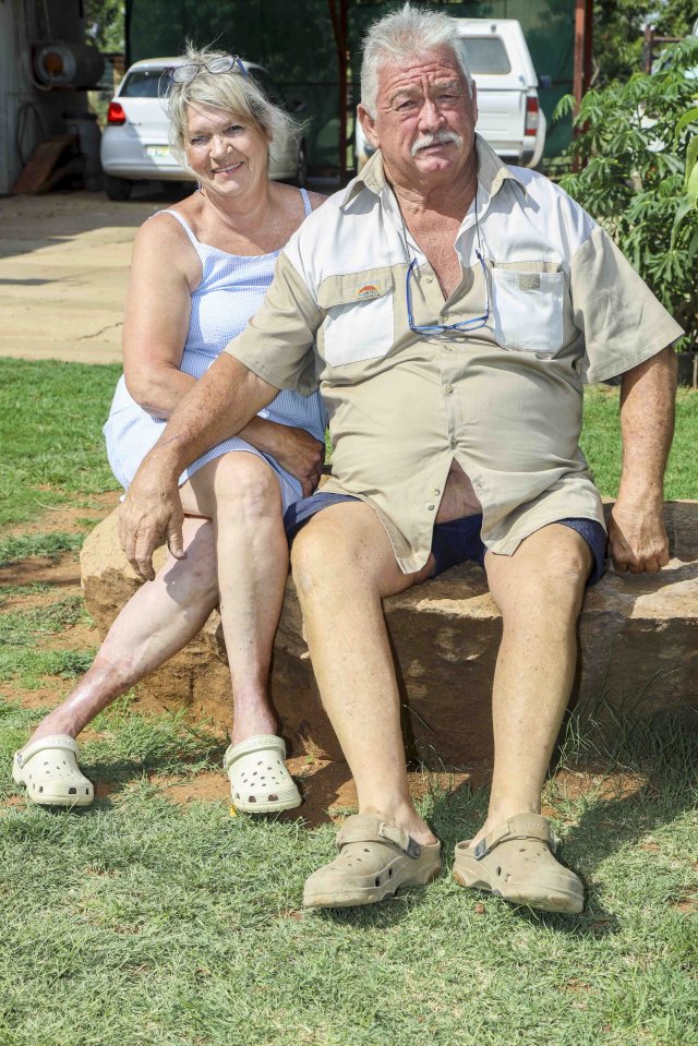 A woman and a man sitting together outdoors.