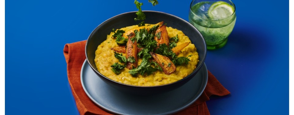 Lentil stew topped with roasted carrots and kale.