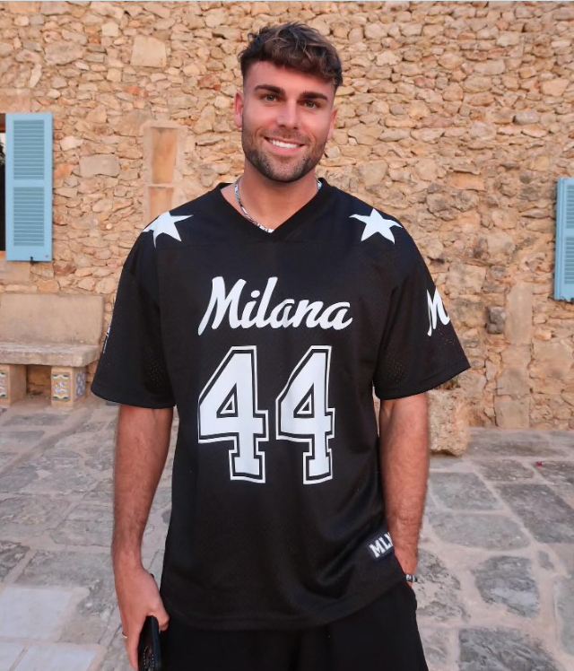 Tom Clare wearing a black jersey with "Milana 44" on it.