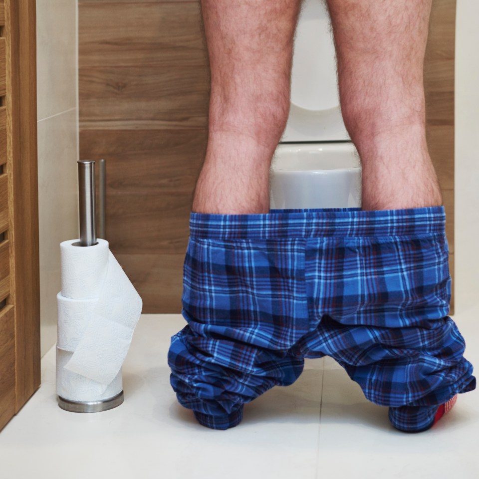 Man urinating in a toilet.