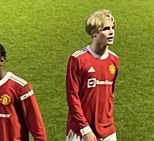 Young man in Manchester United jersey.