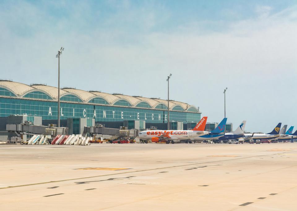 Alicante-Elche Airport with several airplanes parked at the gate.