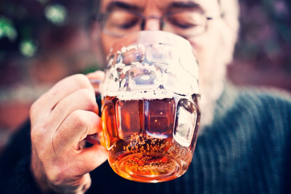 Man drinking a pint of beer.