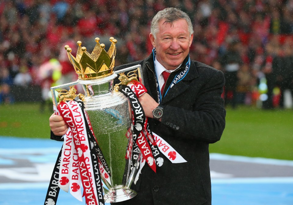 Sir Alex Ferguson holding the Premier League trophy.