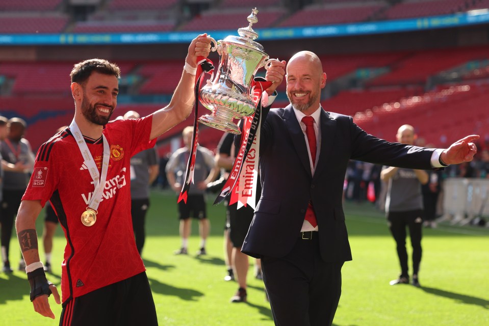 Manchester United's coach and player with the FA Cup trophy.