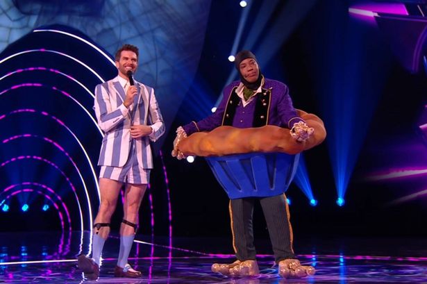 A contestant dressed as a giant cupcake on the Masked Singer stage.