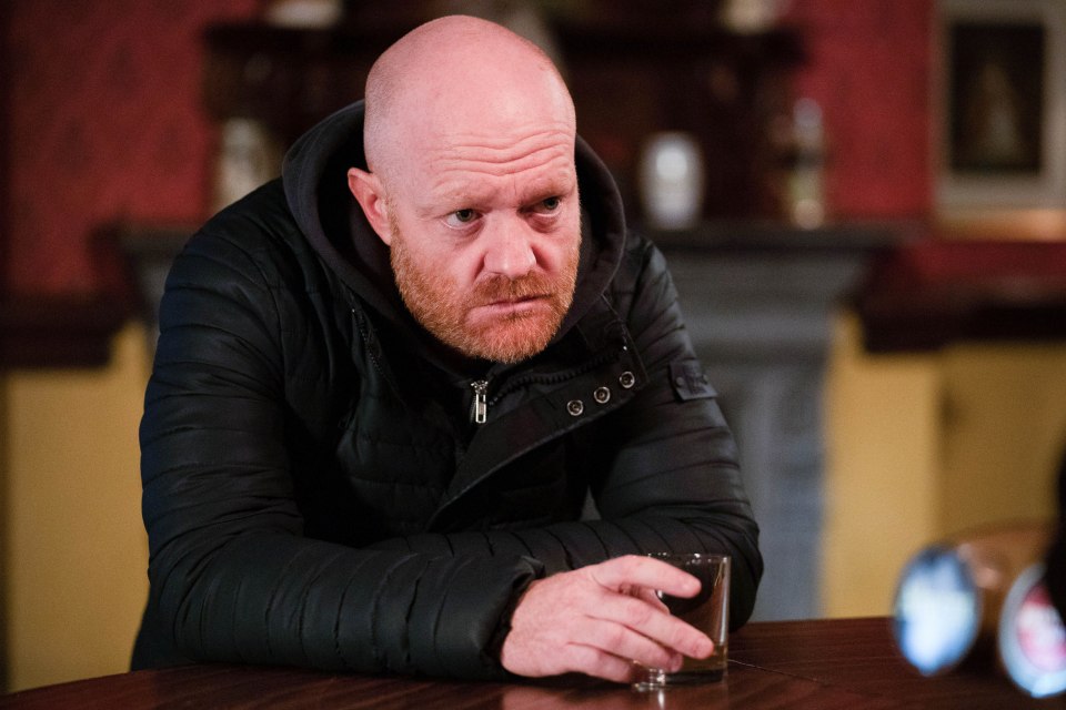 Max Branning from EastEnders sits at a bar, looking pensive.