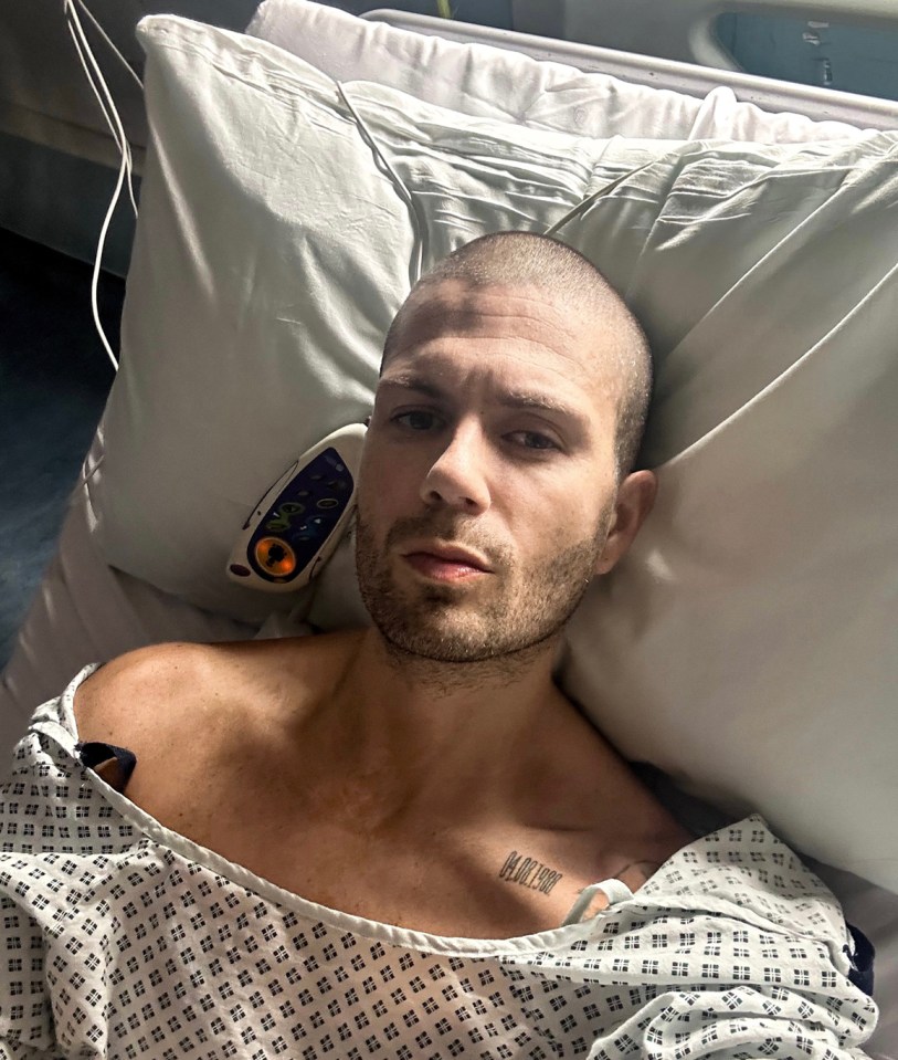 Man in hospital gown lying in a hospital bed.