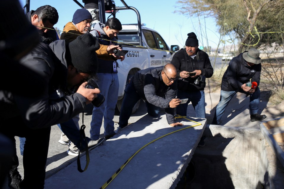 Journalists photograph a closed illegal tunnel at the US-Mexico border.