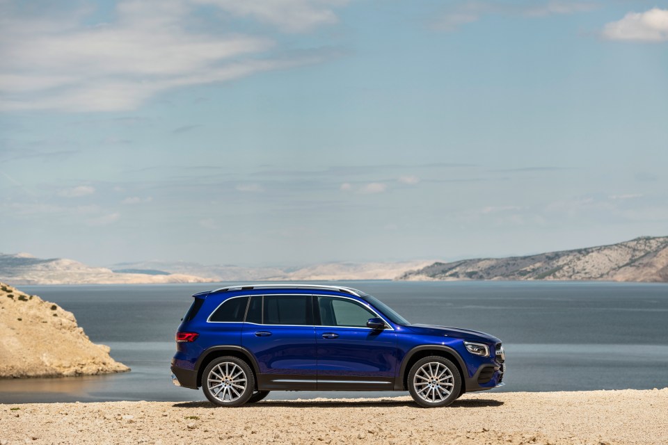 Blue Mercedes-Benz GLB parked by the sea.