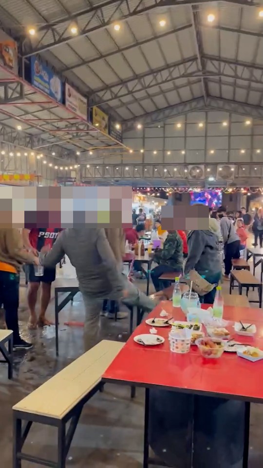 A fight breaks out at a crowded market in Surin, Thailand.