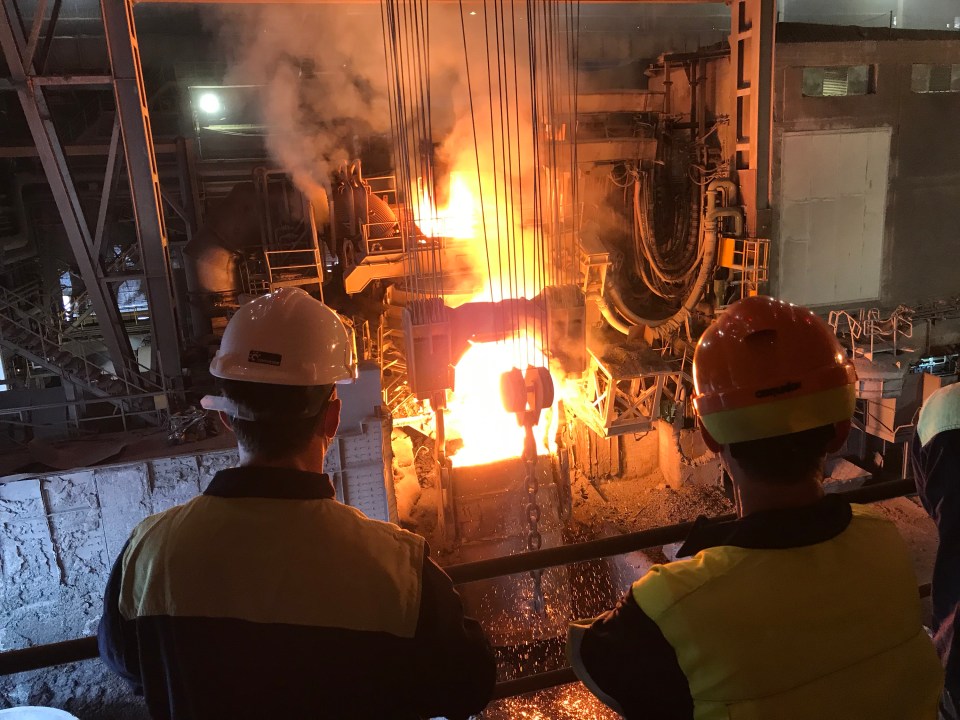 Molten metal being poured in a factory.