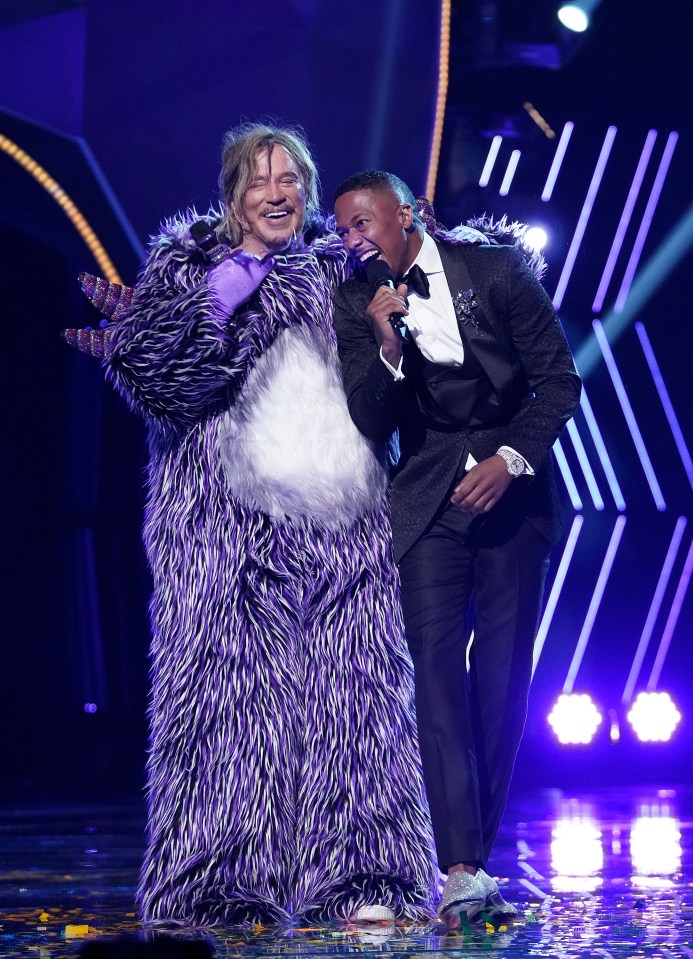 Mickey Rourke in a purple costume with Nick Cannon on The Masked Singer.