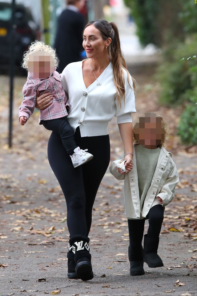 Lauryn Goodman walking with her two children.