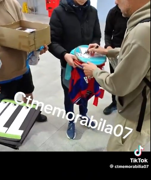 Pep Guardiola signing autographs for fans.