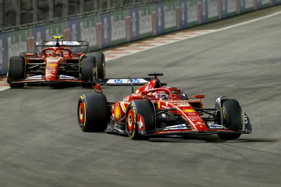 Two Scuderia Ferrari Formula One race cars on a track.