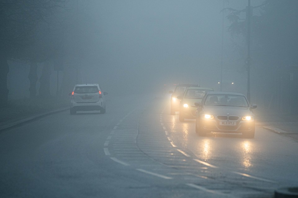 Cars driving in heavy fog.