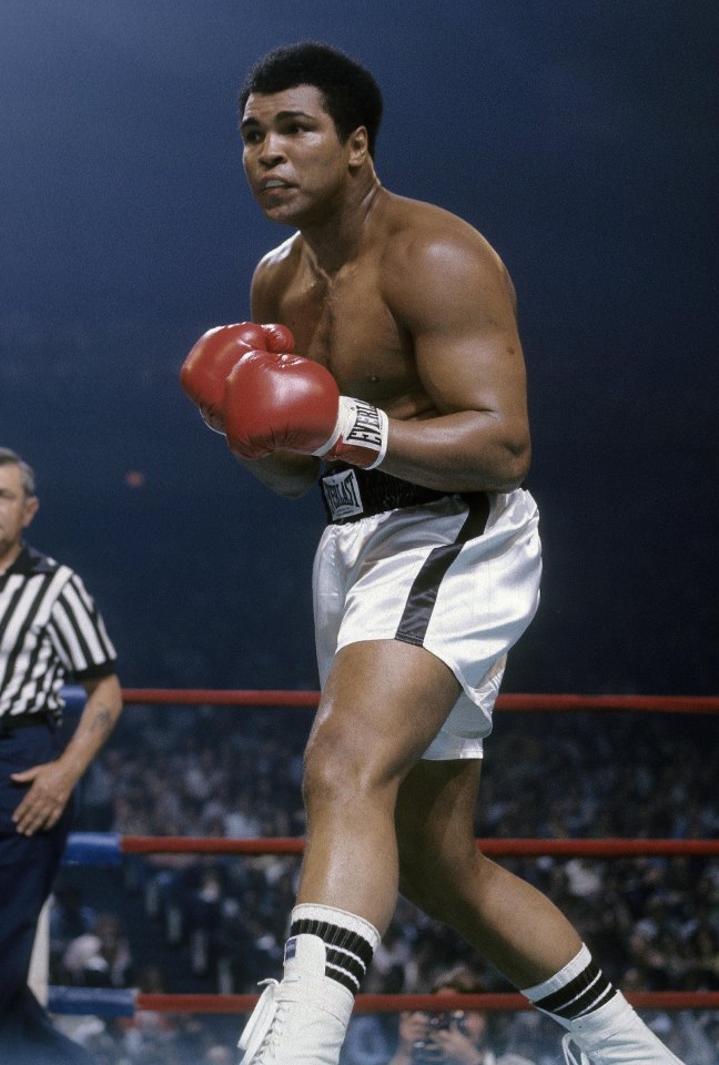 Muhammad Ali boxing in a match.