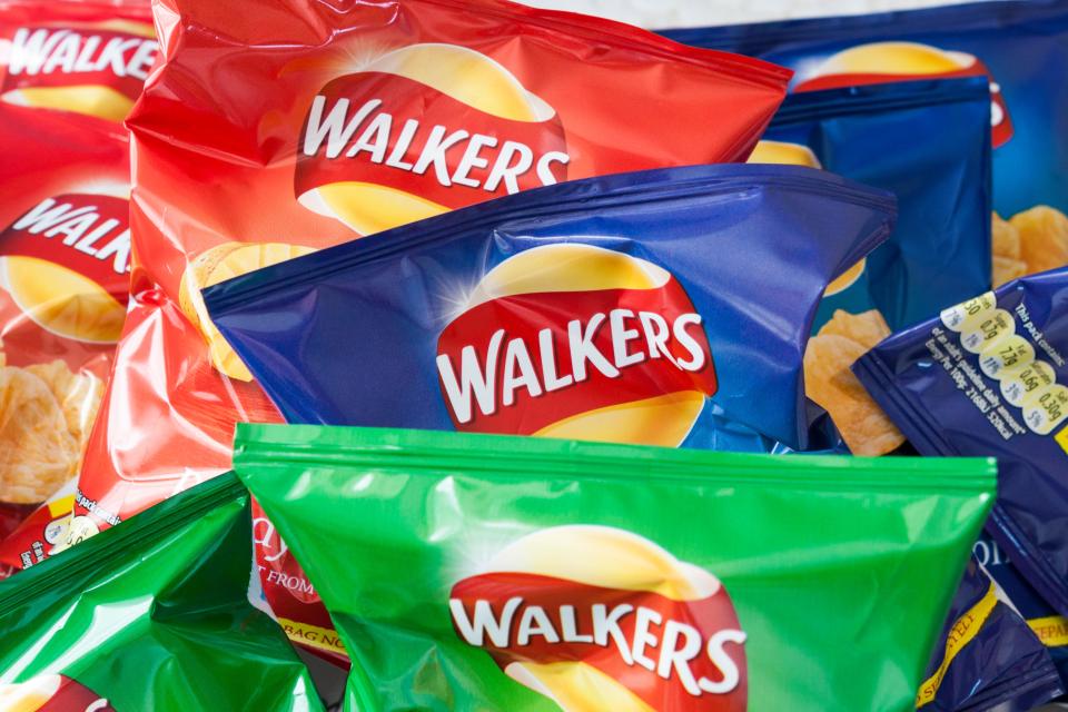 Assorted Walkers crisps packets.