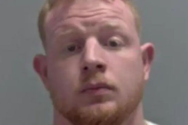 Mugshot of a man with light skin and red hair.