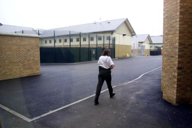 A guard walks past Yarl's Wood Detention Centre.