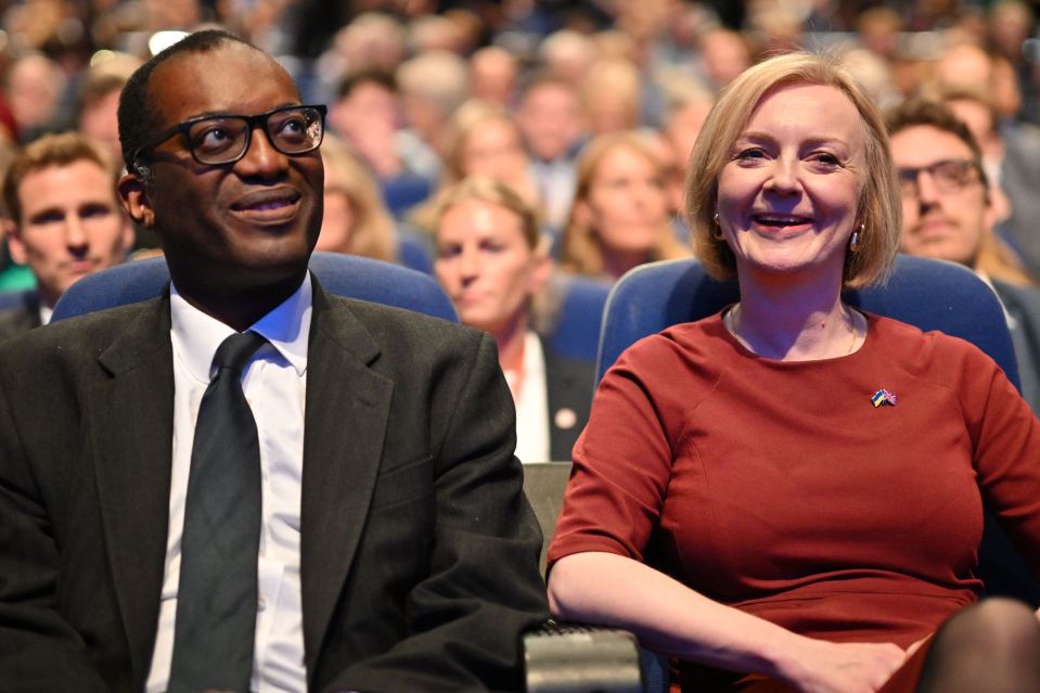 Two people seated in an audience.