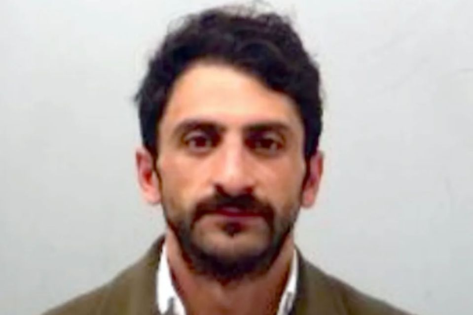 Headshot of a man with dark hair and a beard.