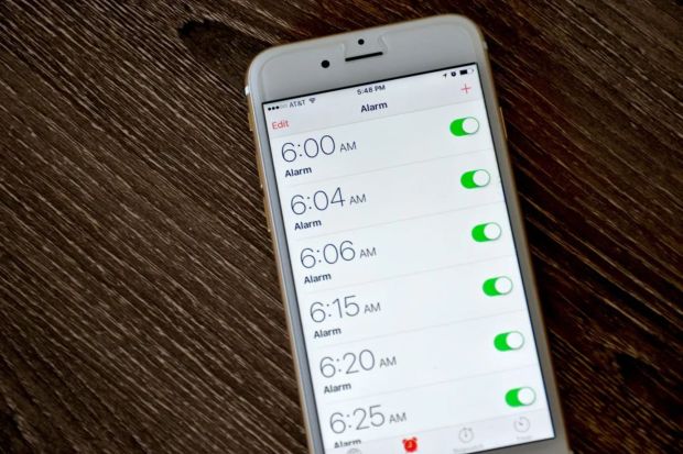 Smartphone displaying multiple alarms set for early morning.