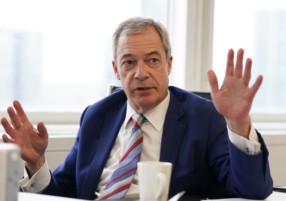 Nigel Farage in a blue suit, giving an interview.