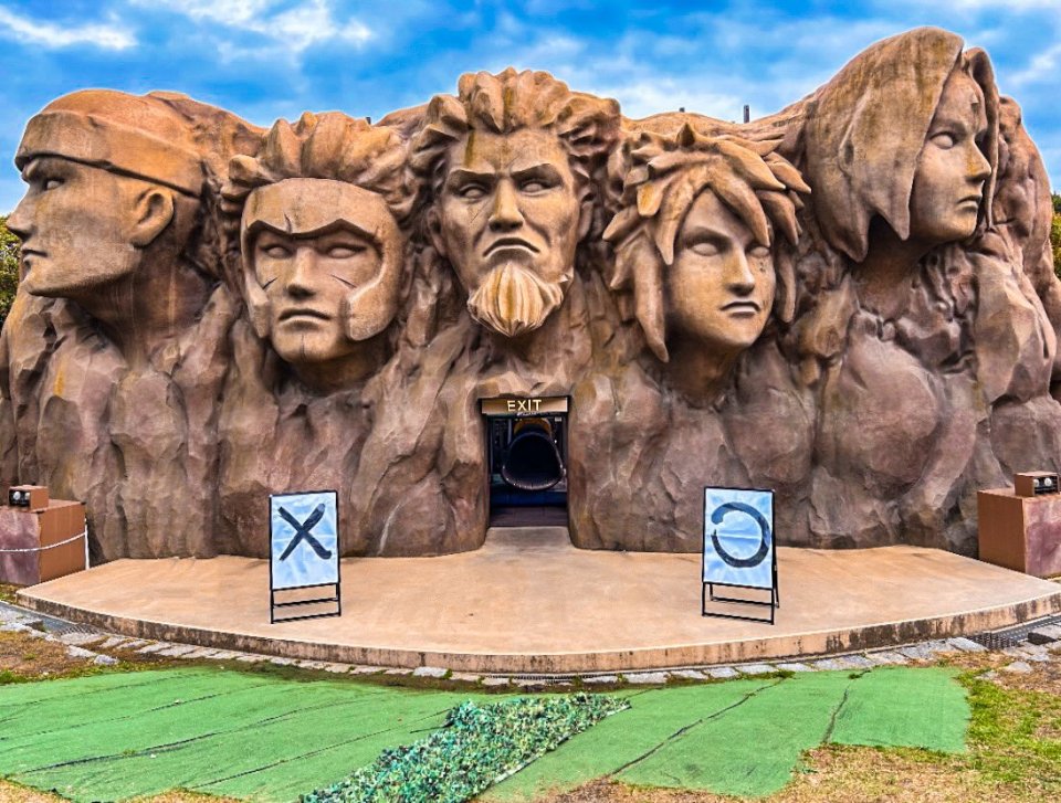 Naruto Shinobi-zato theme park entrance with large stone carvings of characters.