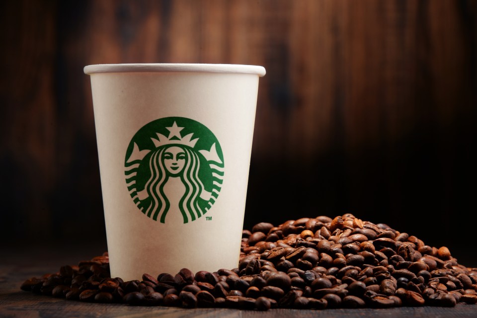 Starbucks coffee cup and coffee beans.