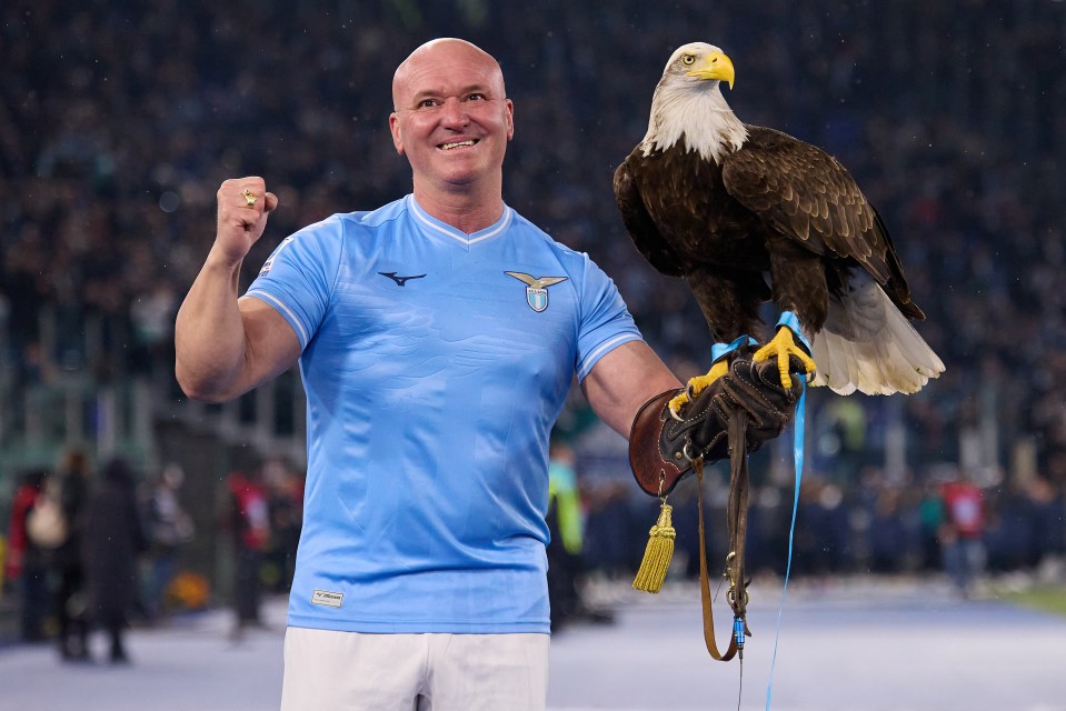 A man in an SS Lazio jersey holds an eagle.