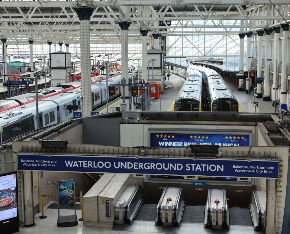 Waterloo Station with trains at platforms and escalators to the underground station.