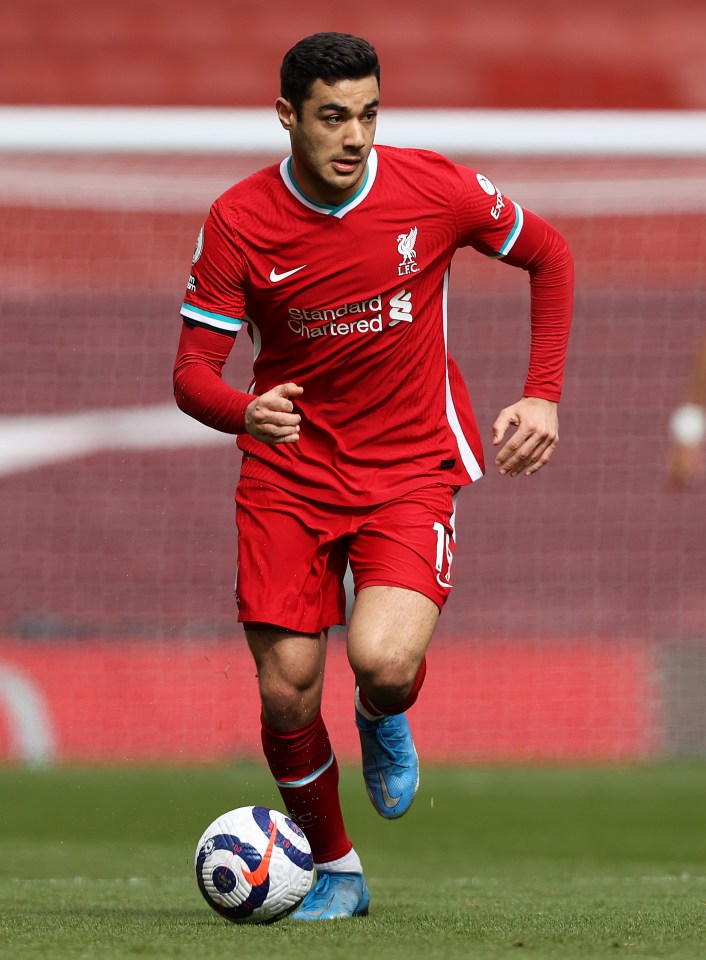 Ozan Kabak of Liverpool FC running with the ball during a soccer match.